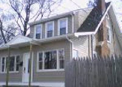 front view of a double story house with fencing on sides