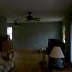 Wide angled view of a well decorated room with ceiling fans