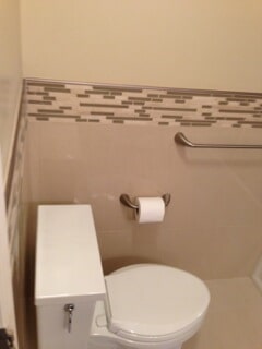 corner view of toilet and toilet paper
