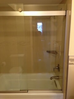 side view of bathtub with the glass door closed