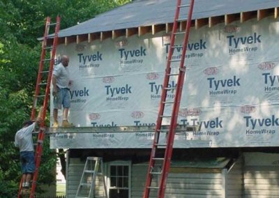 Workers using ladders to work on a new construction