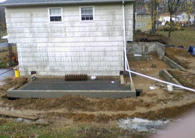 view of the concrete foundation in the backyard of the house