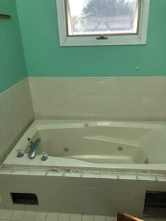 view of bathtub before renovation and remodeling