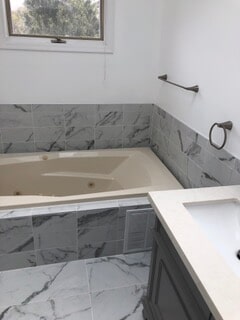 view of the bathtub and sink after remodeling and renovation